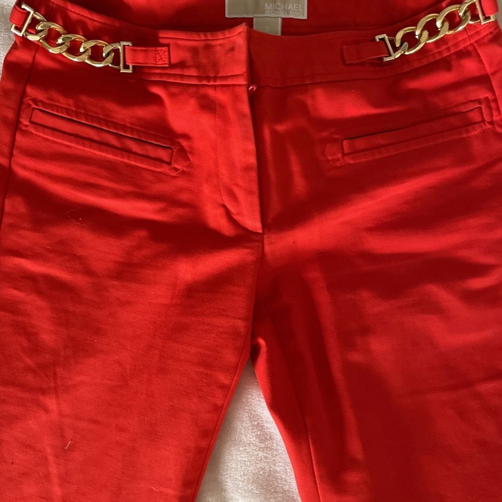 Coral red pants with gold chain detail by Michael Kors